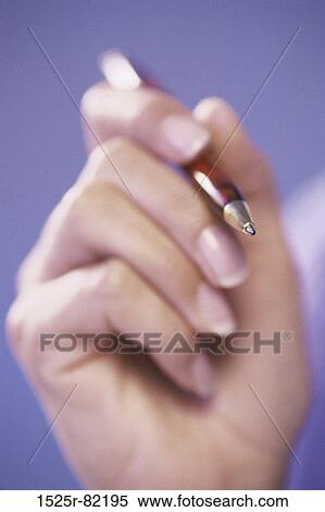 Close-up of a person's hand holding a pen View Large Photo Image Stock Photography - Close-up of a person's hand holding a pen. Fotosearch
