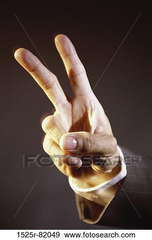 Close-up of a person's hand making the victory sign View Large Photo Image Stock Photo - Close-up of a person's hand making the victory sign. Fotosearch