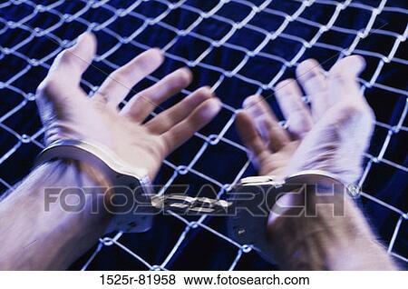 Close-up of a person's hands in handcuffs View Large Photo Image Stock Photo - Close-up of a person's hands in handcuffs. Fotosearch
