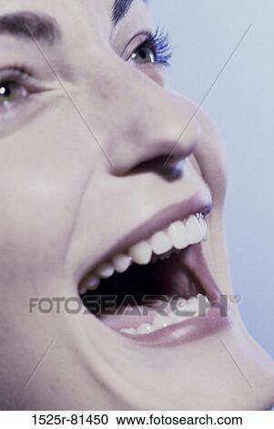 Close-up of a young woman laughing View Large Photo Image Stock Image - Close-up of a young woman laughing. Fotosearch