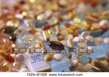 Close-up of assorted pills and capsules on a pill box View Large Photo Image Stock Photograph - Close-up of assorted pills and capsules on a pill box. Fotosearch