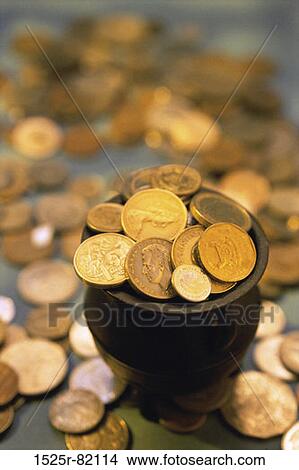 Close-up of gold coins in a pot View Large Photo Image Picture - Close-up of gold coins in a pot. Fotosearch