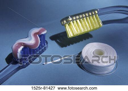 Close-up of toothpaste on toothbrushes and a roll of dental floss View Large Photo Image Stock Photo - Close-up of toothpaste on toothbrushes and a roll of dental floss. Fotosearch