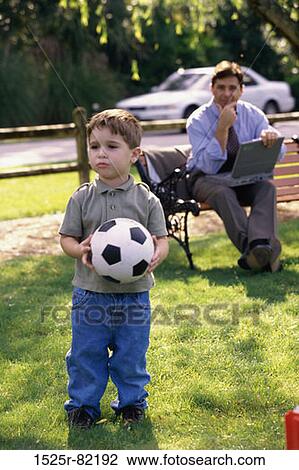 Stock Image - Father and son in a park. Fotosearch