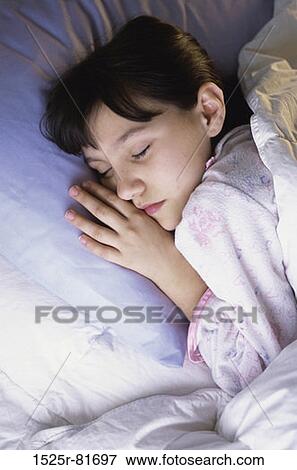 Girl sleeping on a bed View Large Photo Image Stock Photo - Girl sleeping on a bed. Fotosearch