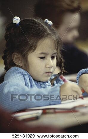Girl writing with a crayon View Large Photo Image Stock Photo - Girl writing with a crayon. Fotosearch