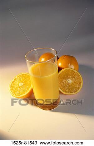 Glass of orange juice and oranges View Large Photo Image Stock Photo - Glass of orange juice and oranges. Fotosearch