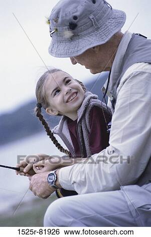 Granddaughter looking at her grandfather View Large Photo Image Stock Photograph - Granddaughter looking at her grandfather. Fotosearch