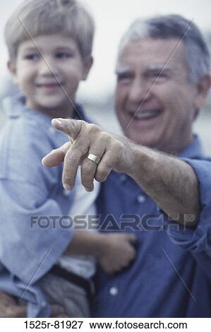 Stock Photo - Grandfather holding his grandson. Fotosearch