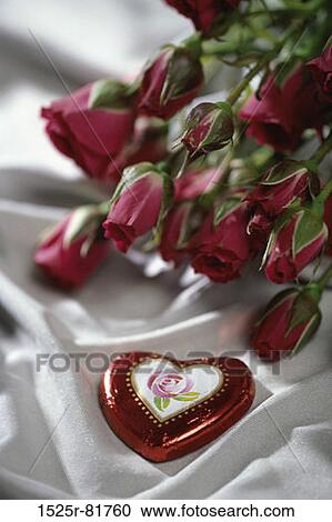 Heart-shaped candy with red roses View Large Photo Image Stock Image - Heart-shaped candy with red roses. Fotosearch