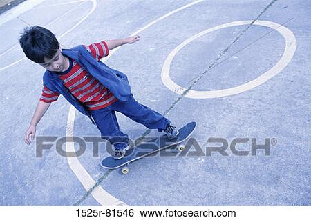 Stock Photograph - High angle view of a boy on a skateboard. Fotosearch