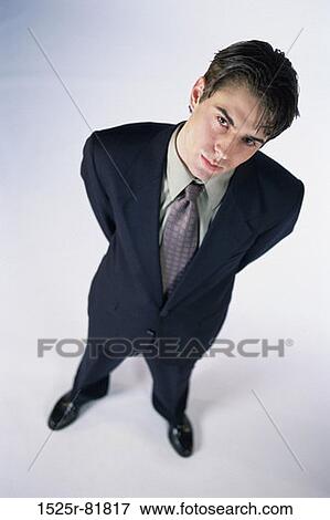 High angle view of a businessman standing with his arms behind his back View Large Photo Image Stock Photo - High angle view of a businessman standing with his arms behind his back. Fotosearch