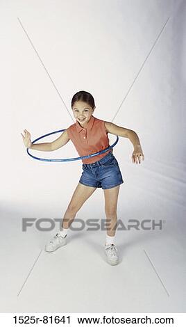 High angle view of a girl playing with a hula hoop View Large Photo Image Stock Image - High angle view of a girl playing with a hula hoop. Fotosearch