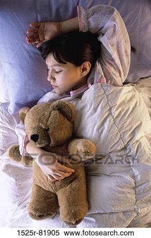 High angle view of a girl sleeping on a bed View Large Photo Image Stock Photography - High angle view of a girl sleeping on a bed. Fotosearch