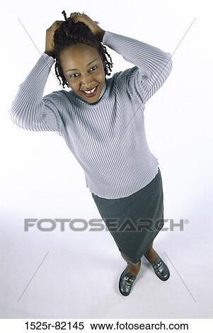High angle view of a young woman holding her hair View Large Photo Image Stock Photography - High angle view of a young woman holding her hair. Fotosearch
