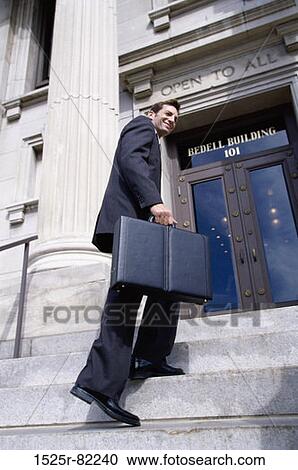 Low angle view of a businessman walking up stairs View Large Photo Image Stock Image - Low angle view of a businessman walking up stairs. Fotosearch