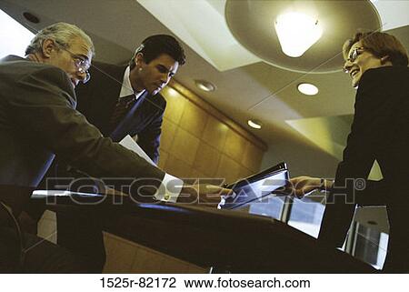 Low angle view of business executives discussing in an office View Large Photo Image Stock Image - Low angle view of business executives discussing in an office. Fotosearch