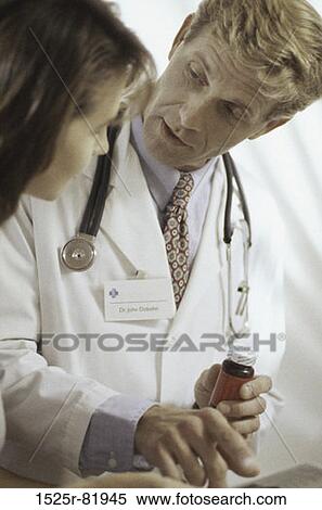 Male doctor talking to a woman View Large Photo Image Stock Photography - Male doctor talking to a woman. Fotosearch