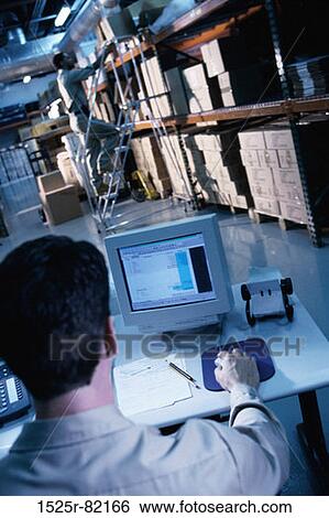 Stock Photograph - Man working on a computer. Fotosearch