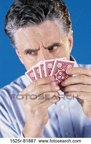 Mature man holding playing cards View Large Photo Image Stock Photo - Mature man holding playing cards. Fotosearch