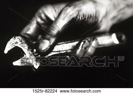 Mechanic holding a wrench View Large Photo Image Picture - Mechanic holding a wrench. Fotosearch