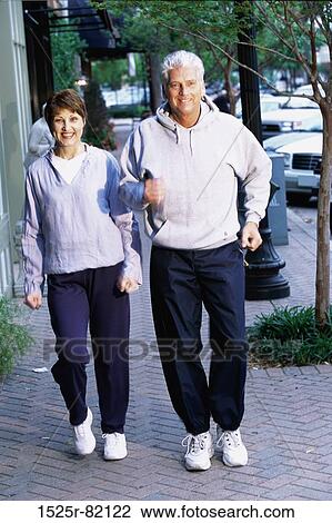 Mid adult couple jogging together View Large Photo Image Stock Image - Mid adult couple jogging together. Fotosearch