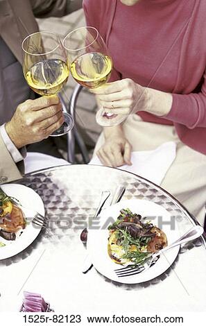 Mid adult couple toasting with wine View Large Photo Image Stock Image - Mid adult couple toasting with wine. Fotosearch