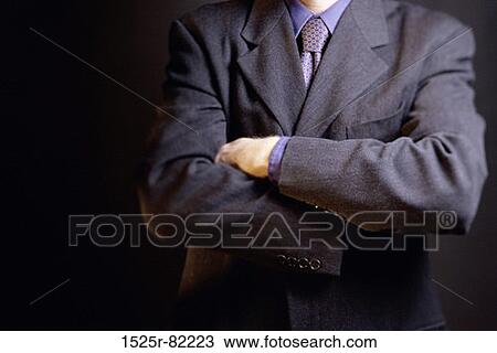Mid section view of a businessman with his arms folded View Large Photo Image Stock Image - Mid section view of a businessman with his arms folded. Fotosearch