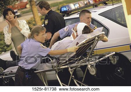 Paramedics putting a patient into an ambulance View Large Photo Image Stock Photo - Paramedics putting a patient into an ambulance. Fotosearch