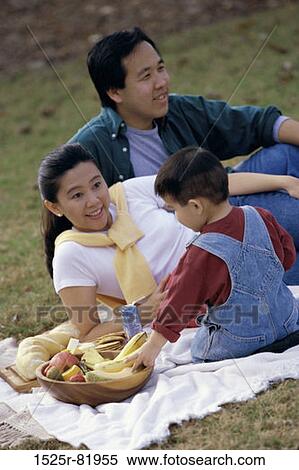 Parents and their son at a picnic View Large Photo Image Stock Photography - Parents and their son at a picnic. Fotosearch