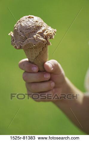 Person holding an ice cream cone View Large Photo Image Stock Image - Person holding an ice cream cone. Fotosearch