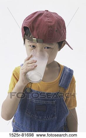 Portrait of a boy drinking a glass of milk View Large Photo Image Stock Photo - Portrait of a boy drinking a glass of milk. Fotosearch