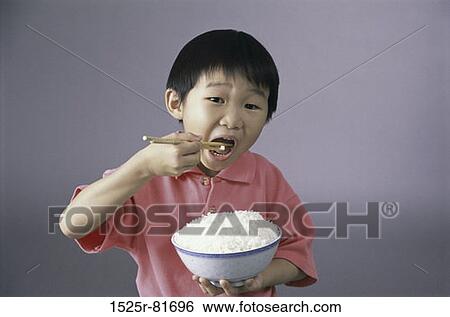 Portrait of a boy eating rice with chopsticks View Large Photo Image Stock Photograph - Portrait of a boy eating rice with chopsticks. Fotosearch