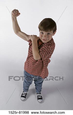 Portrait of a boy flexing his muscles View Large Photo Image Stock Photo - Portrait of a boy flexing his muscles. Fotosearch