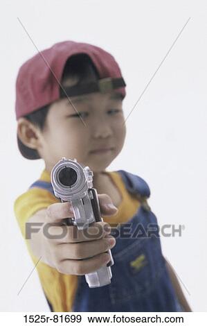 Portrait of a boy holding a toy gun View Large Photo Image Stock Photo - Portrait of a boy holding a toy gun. Fotosearch