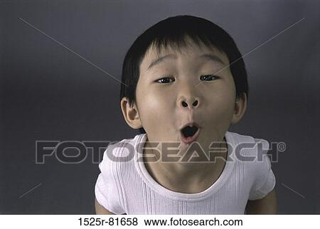 Portrait of a boy making a face View Large Photo Image Stock Photo - Portrait of a boy making a face. Fotosearch