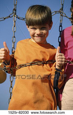 Portrait of a boy on a jungle gym View Large Photo Image Stock Image - Portrait of a boy on a jungle gym. Fotosearch