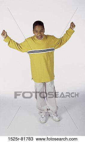 Portrait of a boy standing with his arms raised to the side View Large Photo Image Stock Image - Portrait of a boy standing with his arms raised to the side. Fotosearch