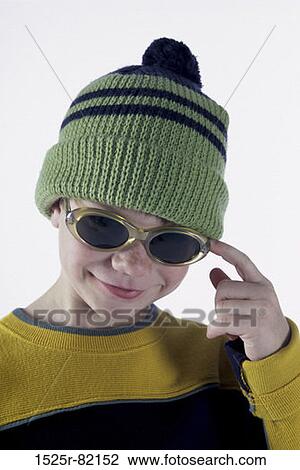 Portrait of a boy wearing a hat and sunglasses View Large Photo Image Stock Image - Portrait of a boy wearing a hat and sunglasses. Fotosearch