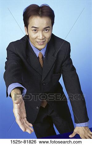Portrait of a businessman holding his hand out View Large Photo Image Stock Photograph - Portrait of a businessman holding his hand out. Fotosearch