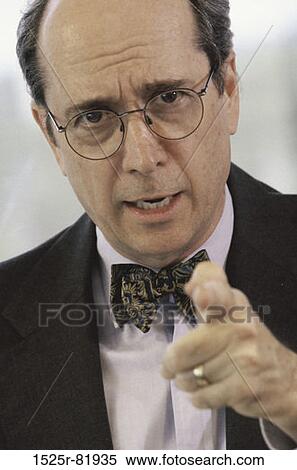 Stock Photography - Portrait of a businessman pointing forward. Fotosearch