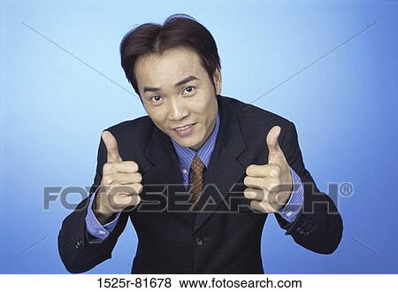 Portrait of a businessman showing thumbs up sign View Large Photo Image Stock Photo - Portrait of a businessman showing thumbs up sign. Fotosearch