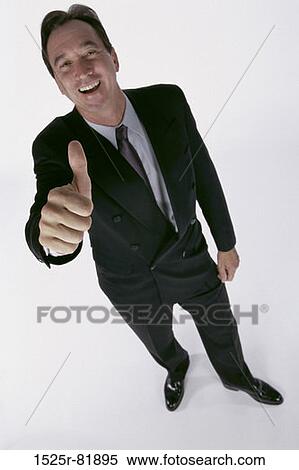 Portrait of a businessman showing thumbs up sign View Large Photo Image Stock Photography - Portrait of a businessman showing thumbs up sign. Fotosearch