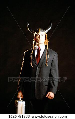 Stock Photograph - Portrait of a businessman wearing a Viking helmet. Fotosearch