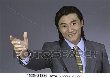 Stock Photograph - Portrait of a businessman with his hand stretched out. Fotosearch