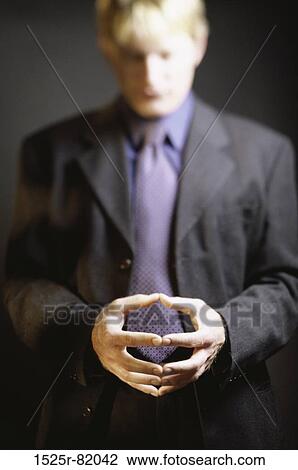 Stock Image - Portrait of a businessman with his hands together. Fotosearch