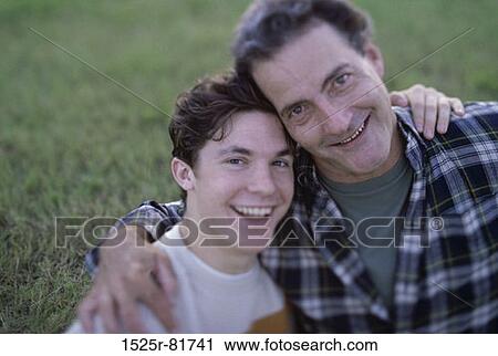 Portrait of a father holding his son View Large Photo Image Stock Image - Portrait of a father holding his son. Fotosearch