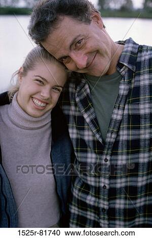 Portrait of a father hugging his daughter View Large Photo Image Stock Image - Portrait of a father hugging his daughter. Fotosearch