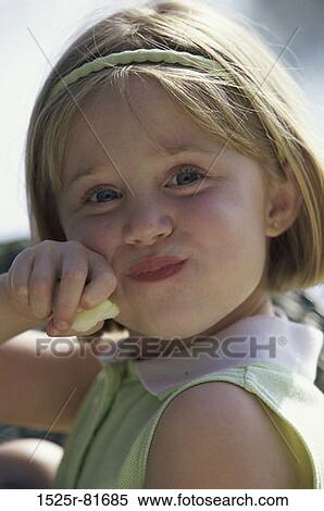 Portrait of a girl eating an apple View Large Photo Image Stock Photography - Portrait of a girl eating an apple. Fotosearch