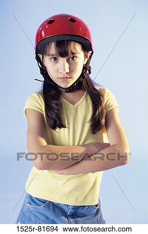 Picture - Portrait of a girl standing with her arms folded. Fotosearch